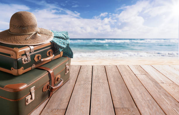 istock Vintage style suitcases at the beach 2065157492