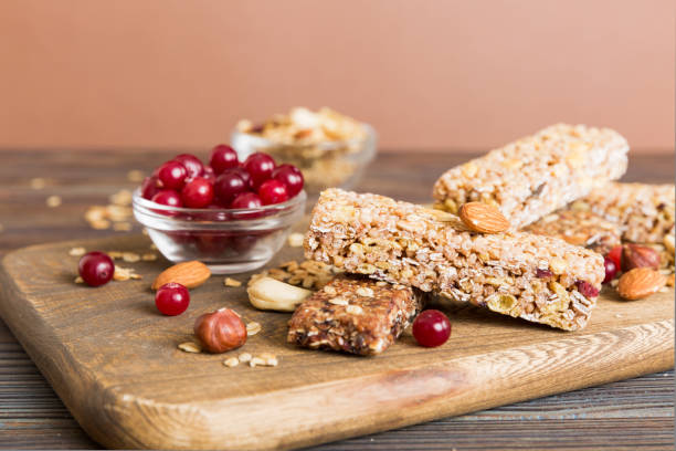 istock Various granola bars on table background. Cereal granola bars. Superfood breakfast bars with oats, nuts and berries, close up. Superfood concept 2065177299