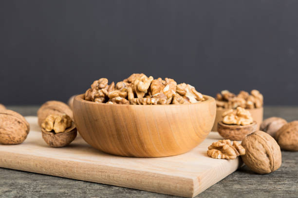istock Fresh healthy walnuts in bowl on colored table background. Top view Healthy eating bertholletia concept. Super foods 2065177857