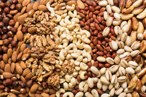 istock different nuts background. Close up, top view, flat lay. Walnut, pistachios, almonds, hazelnuts and cashews 2065177866