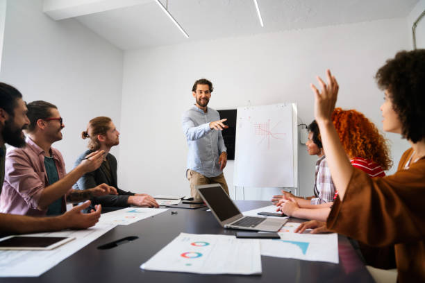 istock Smiling diverse colleagues gather in boardroom brainstorm discuss financial statistics together 2065196092