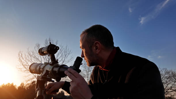 istock Amateur astronomer observing Sun eclipse and Sun with a telescope and special solar filter. 2065198307