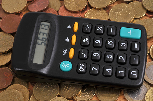Calculator placed on a background of euro coins