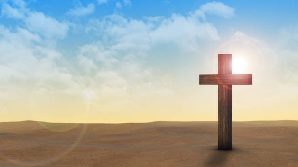 This captivating stock image featuring a Christian cross standing amidst dry land. Against a backdrop of barren soil and a vast sky, the cross symbolizes hope and reverence, evoking a sense of connection to the divine amidst earthly trials.