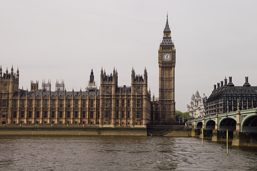 Head-on view of Big Ben and the Houses of Parliament with the Westminster Bridge approach to the right.