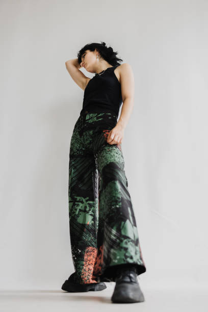 istock Confident Woman Looking To Her Right Side, Wearing Multicolored Flare Pants 2065235599