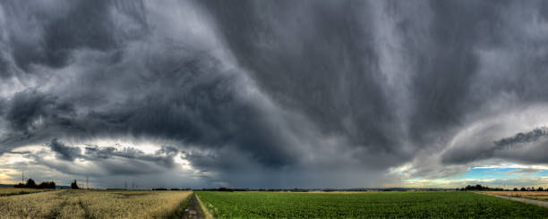 istock A thunderstorm front with gray, dramatic and threatening cumulonimbus clouds in the sky over a field with a horizon 2065245162