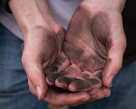 A closeup of dirty palms of hands
