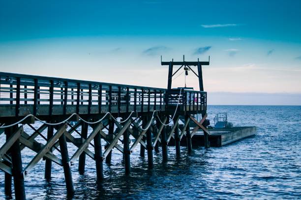 istock the pier is empty and has wooden posts, ropes and lights 2065254953
