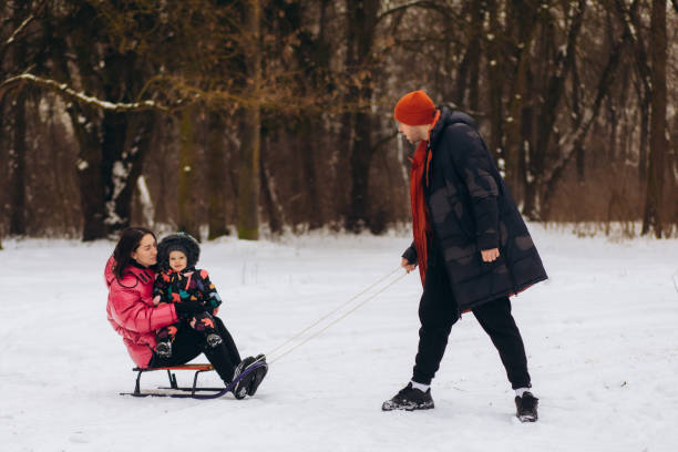 istock happy family with sled walking in winter forest 2065282627
