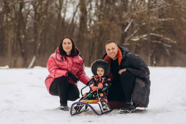 istock happy family with sled walking in winter forest 2065282628