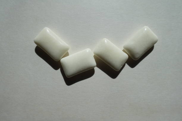 istock Group of four white rectangular pieces of chewing gum 2065285297