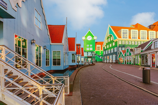 Colorful and unconventional modern and traditional architecture of  Dutch houses stacked atop each other in Zaandam, Netherlands. These fairytale-like modern architectural buildings feature whimsical motifs, showcasing the unique and playful Dutch architectural style.