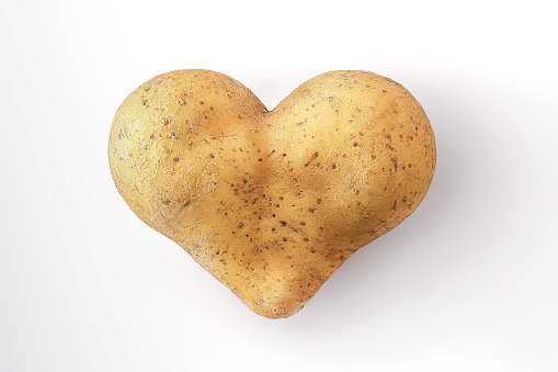 Heart shaped potato, isolated on white
