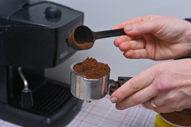 istock women's hands pour coffee into the coffee machine 2065305711