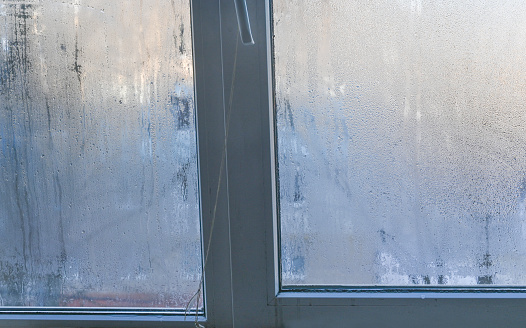 a wet window. the glass is fogged up due to high humidity