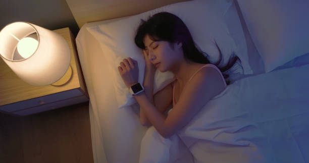 istock asian woman sleep with smartwatch 2065323477