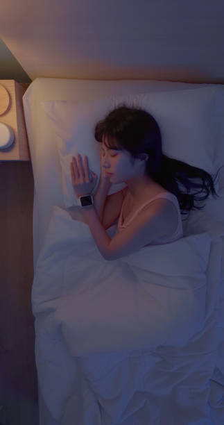 istock asian woman sleep with smartwatch 2065323980