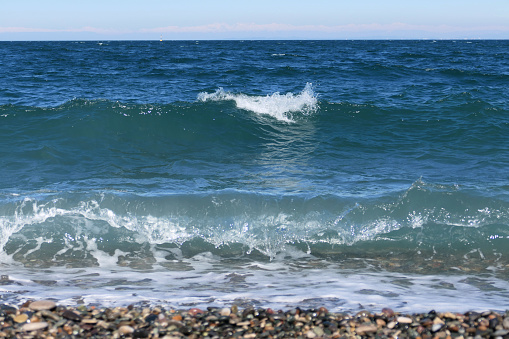 Sea waves breaking on a pebble beach on the Black Sea coast.