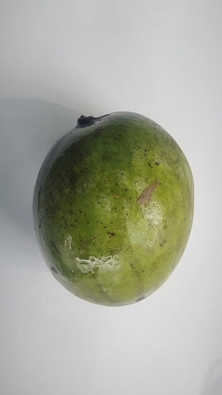 Kuini fruit (Mangifera odorata) on a white background