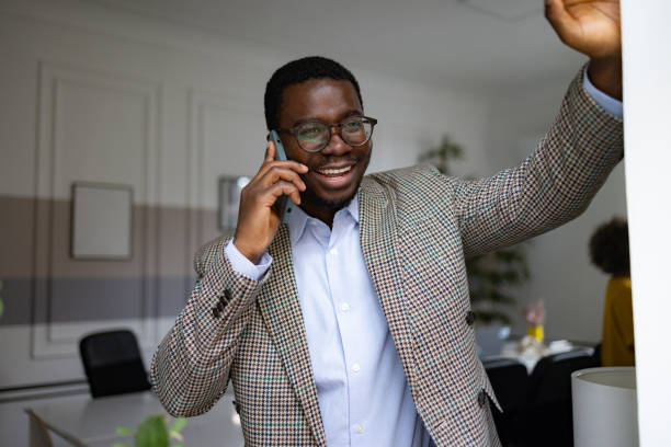 istock Happy black entrepreneur talking on mobile phone in the office. 2065360376
