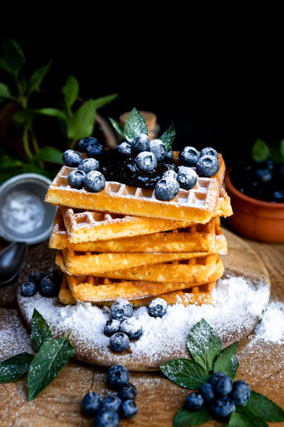 istock Waffles with fresh blueberries and powdered sugar on the rustic table. Freshly made Belgian waffles 2065374973