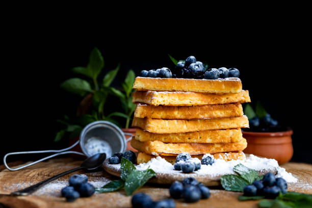 istock Waffles with fresh blueberries and powdered sugar on the rustic table. Freshly made Belgian waffles 2065374975