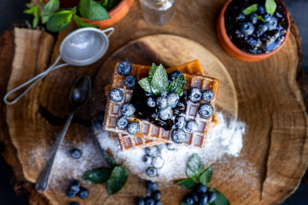 istock Waffles with fresh blueberries and powdered sugar on the rustic table. Freshly baked Belgian waffles 2065374976