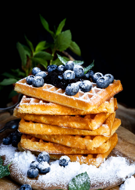 istock Waffles with fresh blueberries and powdered sugar on the rustic table. Freshly made Belgian waffles 2065377085