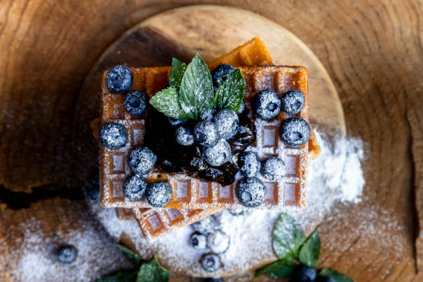 istock Waffles with fresh blueberries and powdered sugar on the rustic table. Freshly baked Belgian waffles 2065377089