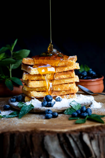 istock Honey pouring on Waffles with fresh blueberries on the rustic table. Freshly made Belgian waffles 2065378808