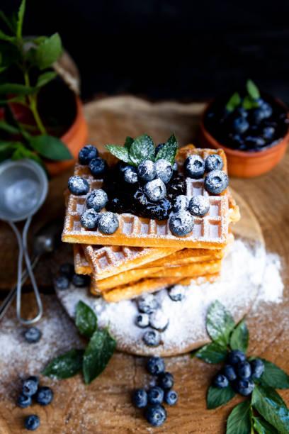 istock Waffles with fresh blueberries and powdered sugar on the rustic table. Freshly made Belgian waffles 2065378820