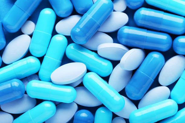 istock Background of blue pills and capsules 2065380895