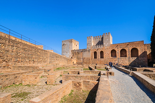 Tourists visiting the Alcazaba (or citadel), the oldest part of the Alhambra of Granada, the monumental complex that is the main landmark of the city.