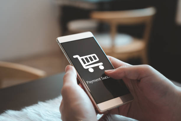 istock Person using mobile smartphone and application showing online shopping symbol with payment successful message. 2065407016