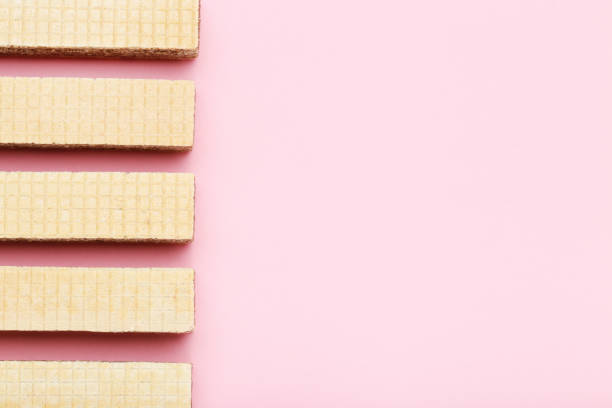 istock Sweet wafer sticks on pink background 2065413054