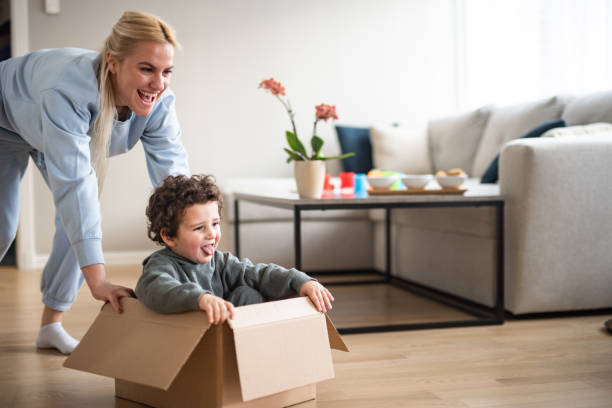 istock Mother and a boy are playing with a box 2065418364