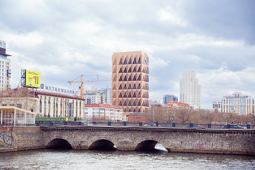 Headquarters of Russian copper company by architect Norman Foster and Iset river bridge. red brown pineapple skyscraper. Copper House building Yekaterinburg, Russia 5.5.23