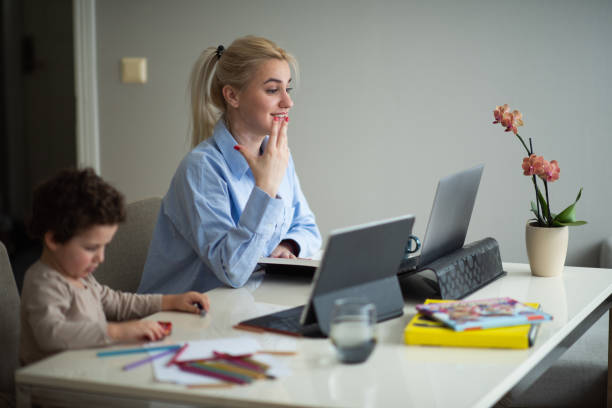 istock Mom works while baby plays 2065419917