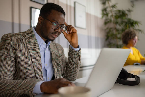 istock Worried black businessman reading a problematic e-mail on laptop in the office. 2065423303