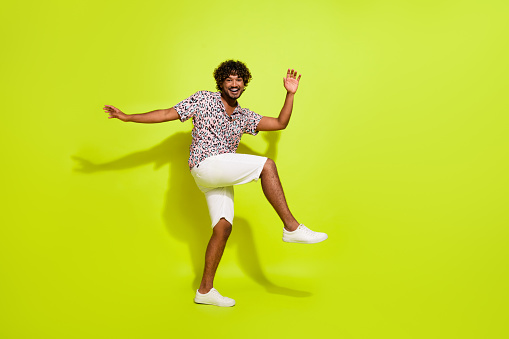 Full body photo of attractive young male dance have fun energetic dressed stylish leopard print clothes isolated on yellow color background.