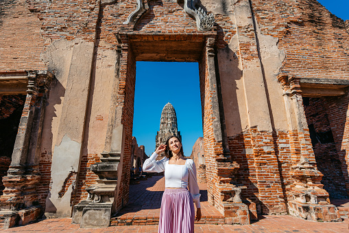 Portrait of a young woman at Wat Ratchaburana in Ayutthaya historical park in Ayutthaya in Thailand.