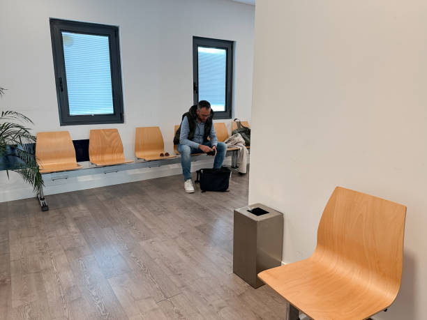 Waiting man sitting in the waiting room of a private medical clinic
