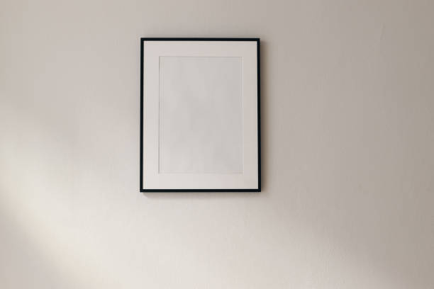 istock Artistic mockup template. Black vertical picture frames on beige wall background in sunlight. Poster display at home, minimal Scandinavian design, no people. Elegant apartment concept. Template 2065451250