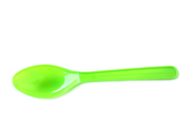 Green plastic disposable spoons isolated on white background. Concept, equipment for eating utensil,