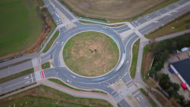 Time lapse of road traffic at a big road intersection. Recorded from a drone with a long exposure time so that the vehicles are blurry and the time passing quickly is visible.