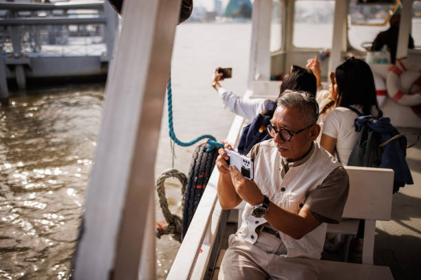 Man and women tourists enjoying on a boat ride in Bangkok.