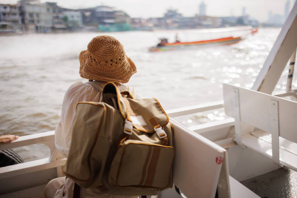 Woman tourist enjoying on a boat ride in Bangkok.