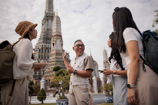 Private tourist guide explaining the city history to women tourists.