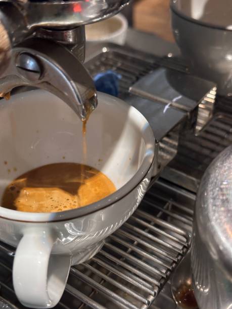 istock Coffee dripping into the cup from the coffee machine 2065507683